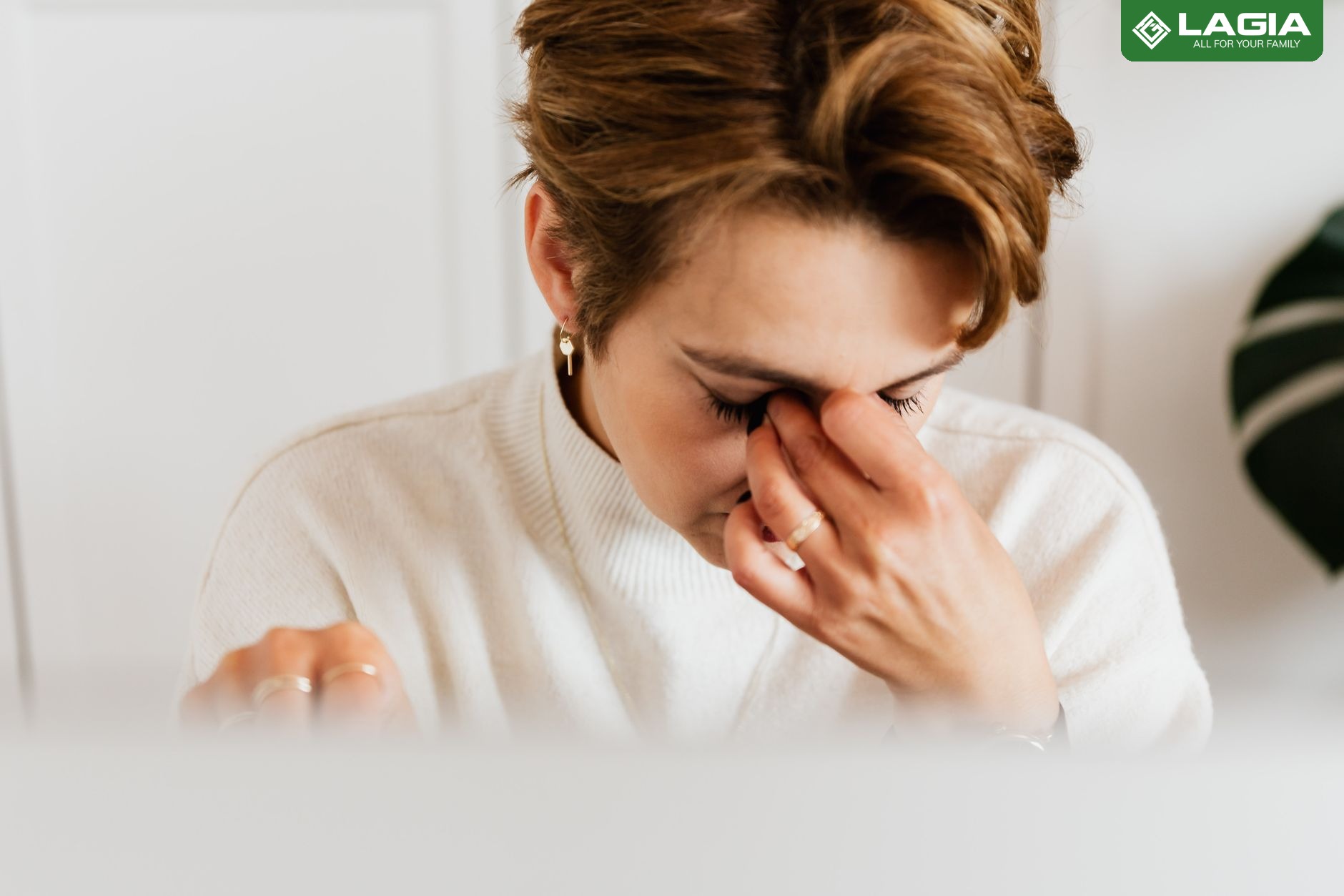 Người phụ nữ đau đầu, day trán vì thiếu máu não do ngồi làm việc lâu, căng thẳng kéo dài